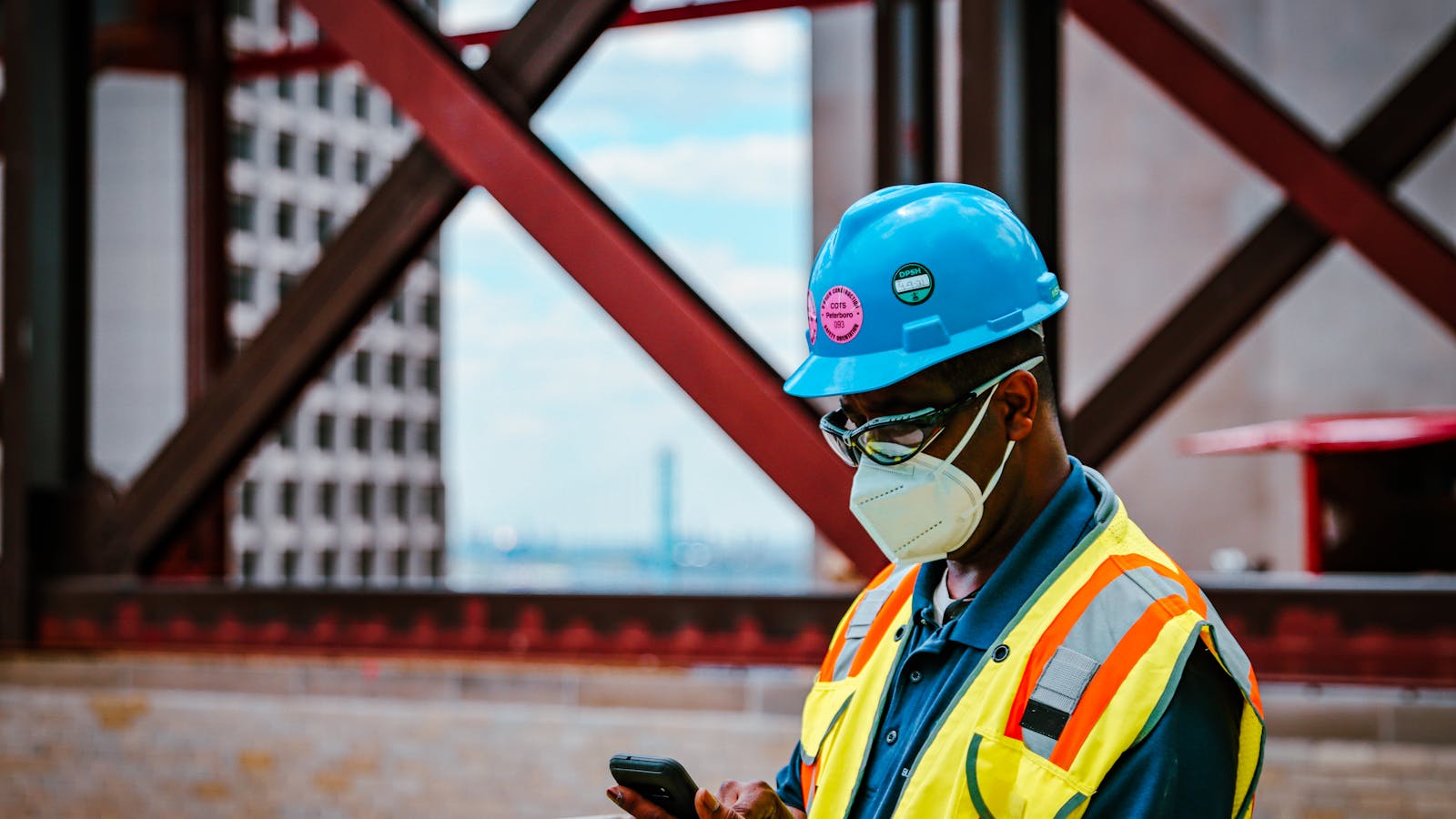 A contractor's phone ringing on a work truck dashboard with tools and a clipboard visible — capturing the choice between answering and finishing the job at hand.